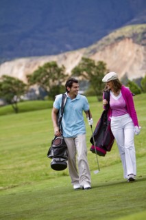 Hispanic couple playing golf together