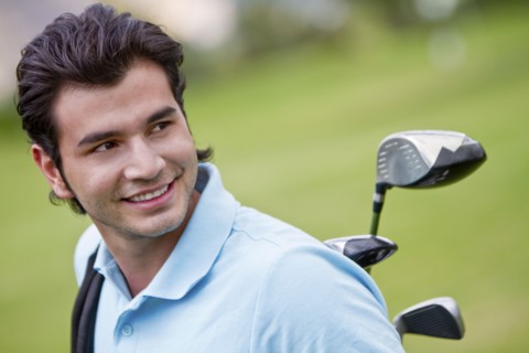 Hispanic man playing golf