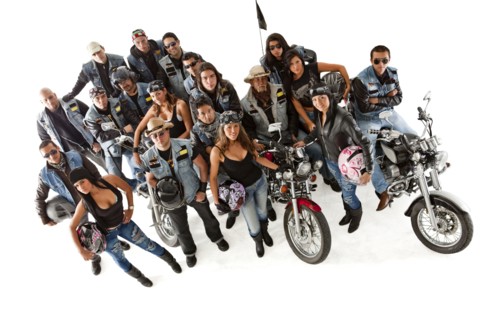 Hispanic bikers standing with motorcycles