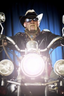 Hispanic biker sitting on motorcycle