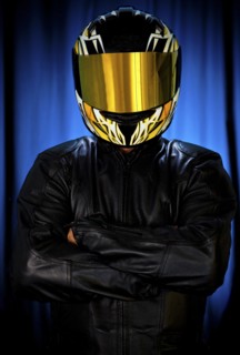 Hispanic biker in leather and reflective helmet