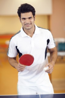 Hispanic man playing ping pong