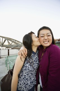 Chinese mother kissing daughter