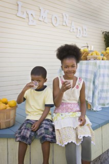 Mixed race brother and sister drinking lemonade