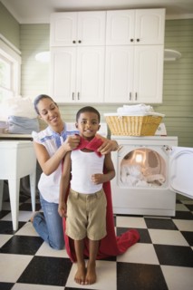 Mixed race mother tying towel to son