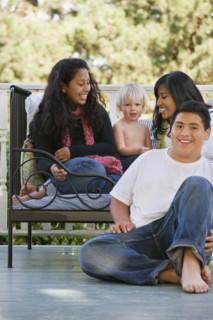 Hispanic family sitting on porch