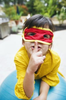Mixed race girl wearing mask and gesturing