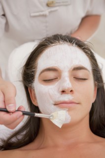 Woman having facial spa treatment