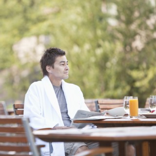 Man enjoying breakfast on outdoor patio