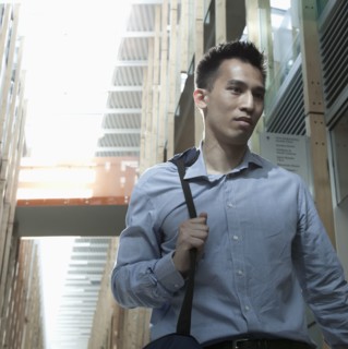 Chinese businessman walking on urban street