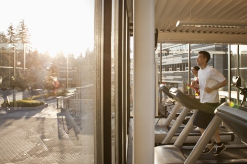 Man running on treadmill in health club