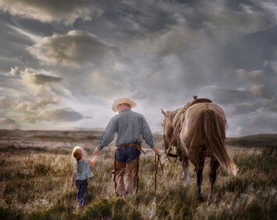 Caucasian father and daughter walking horse in field