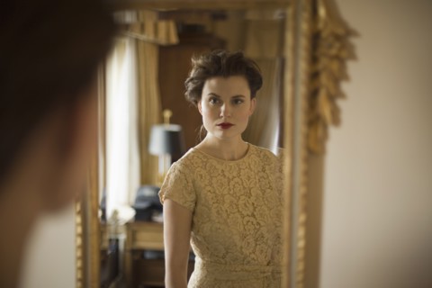 Woman wearing fancy dress looking in mirror