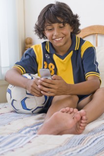 Mixed Race boy dialing cell phone