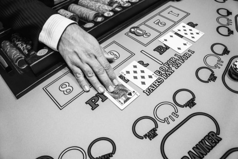Hand of dealer at baccarat table