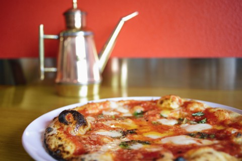 Pizza on plate in pizzeria