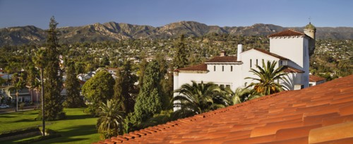 Detail red tile roof and view of houses on mountainside