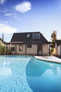 Exterior view of bungalow with swimming pool