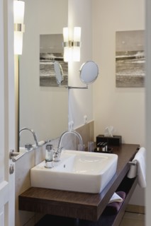 Sink on wooden countertop in domestic bathroom