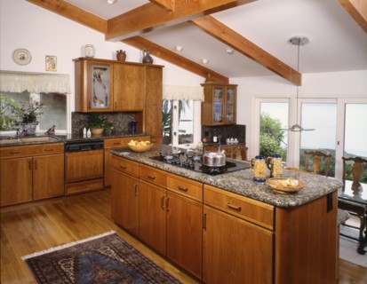 Kitchen with hardwood floor and pitched ceiling