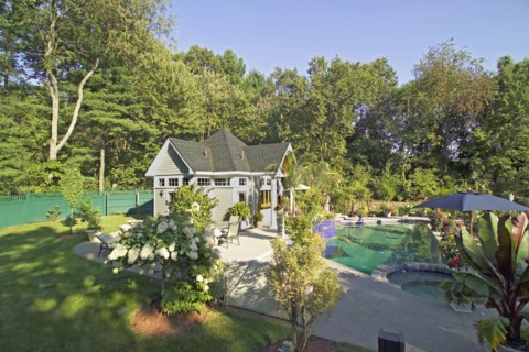 Swimming pool in front of pool house