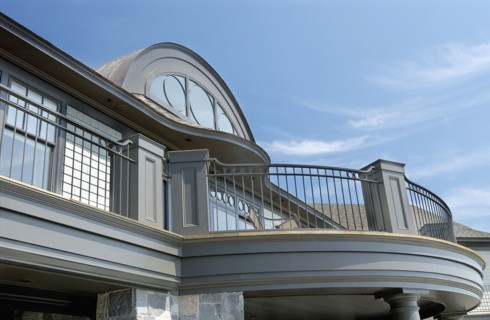 Exterior of home with round top window and balcony