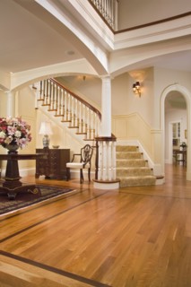 Foyer with maple hardwood floors and carpeted staircase