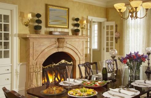 Traditional dining room with fireplace and several place settings