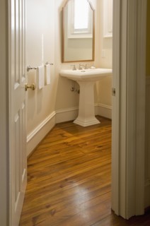 View into small bathroom with pedestal sink