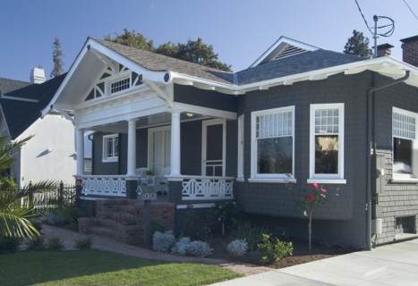 Front exterior view of a blue bungalow with white trim