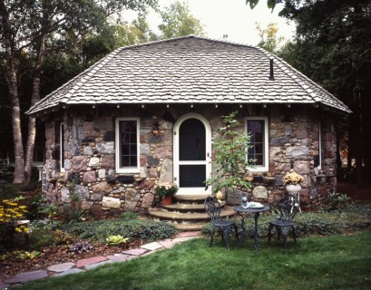 Exterior front view of a stone cottage with shingled roof at Charlevoix