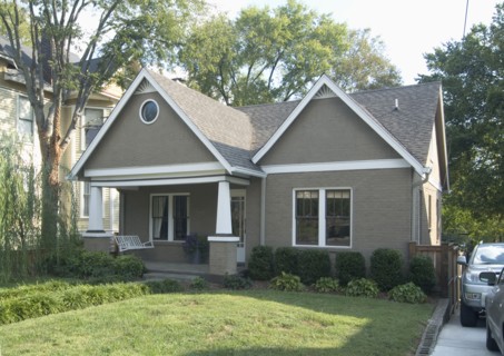 Front exterior of a one story bungalow with white trim at Nashville