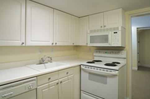 White stove and kitchen in empty apartment
