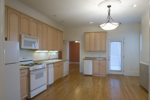 Hardwood floor in spacious traditional kitchen