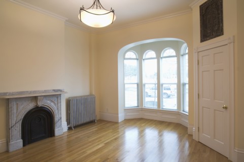 Empty room in apartment with hardwood floor and bay window