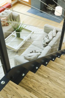 Detail top of wooden staircase overlooking living room