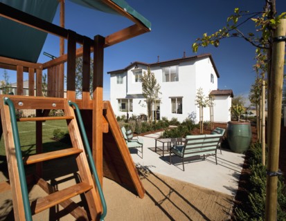 Swingset behind multiple story home