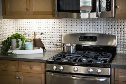 Stainless steel appliances in traditional kitchen