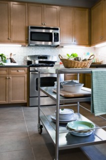 Stacks of dishes on chefs cart in domestic kitchen