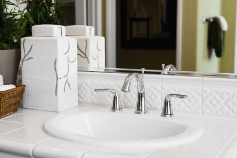 White tile countertop surrounding bathroom sink