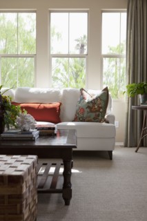 Couch with coffee table against window in the living room at home