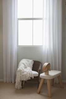 Kid's seats in front of a window at home