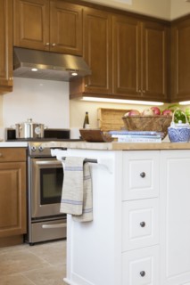 Kitchen with brown cabinets and island at home