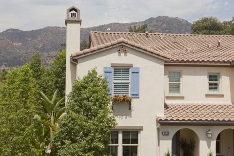 Exterior shot of a residential structure with trees and mountain
