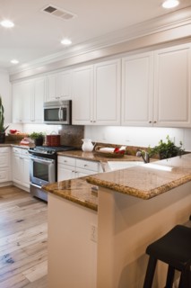 View of a kitchen having white cabinets at home