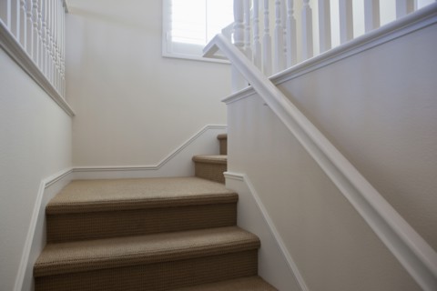 Close-up of stairs with white walls at home