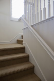 Close-up of stairs with white walls at home