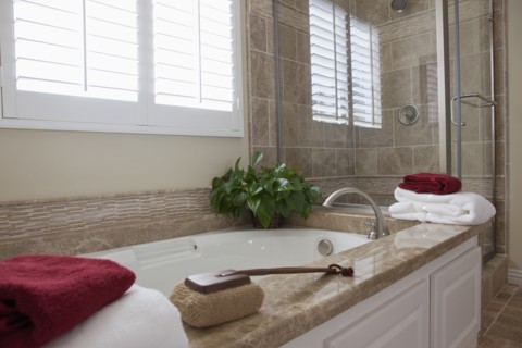 Contemporary bathroom with bath and glass shower at home