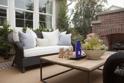 View of sitting area with fireplace and plants at a patio