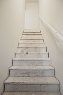 Close-up of white stairs with wall at home